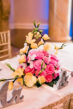 a bouquet of flowers sitting on top of a table next to the number 20 sign