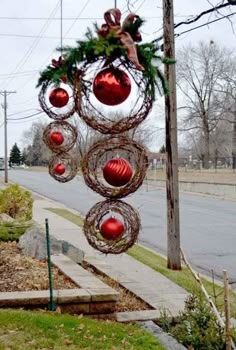 christmas decorations hanging from the side of a street