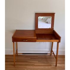 a wooden desk with a mirror on it