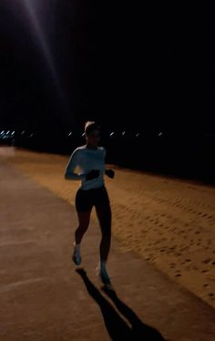 a man running down a road at night