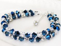 "Details: ~ 6mm Metallic blue bicones  ~ Silver plated rhinestones ~ Measurements: 7 1/2\" plus1\" extender * My jewelry is hand made and made to order * Please allow 1-2 weeks for large/custom orders to be completed * Beautiful Bridal Bracelet and Wonderful Gift for your Bridal Party * Matching Necklace is available (click the link below) * Jewelry will come in a gift box ready for gift giving: either customized or standard. Please leave a message at checkout Matching Necklace: https://www.etsy Blue Wedding Bracelet, Wedding Bridesmaids Gifts, Beach Wedding Bridesmaids, Suffolk Va, Blue Beaded Bracelets, Diy Jewelry Unique, Bridal Earrings Drop, Blue Bridal, Crystal Blue