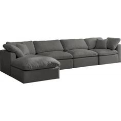 a large sectional couch with pillows on the top and bottom part, in grey fabric