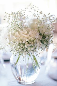 a vase filled with white flowers on top of a table