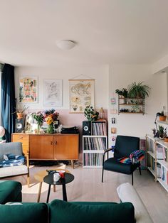 a living room filled with furniture and lots of books on top of a book shelf