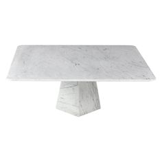 a white marble table with an octagonal base and two square bases on the top,