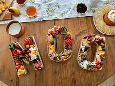 the letters made out of fruits and vegetables are sitting on a table with other food items