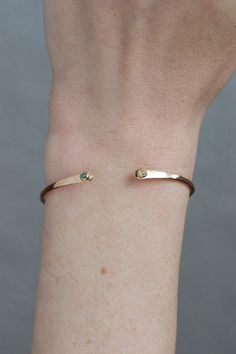 When you need just a small hint of sparkle but want a substantial amount of hardware, choose our gold cuff accented by a pair of 2mm faceted stones. Select whichever birthstone you love most! Recycled 14 Karat Gold cuff Select Your Own stones: choose from garnet, amethyst, aqua, diamond, emerald, pearl, ruby, peridot, sapphire, opal, citrine, or turquoise. Adjustable cuff fits any wrist Made to order - allow about 2-3 weeks for production Blue Sapphire Bracelet, Diamond Cuff Bracelet, Fine Engagement Rings, Aquamarine Birthstone, Sapphire Wedding Rings, Garnet And Gold, Gold Cuffs, Sapphire Bracelet, Opal Bracelet