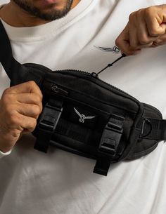 ELEV Tactical Crossbody Bag, minimalist yet intentional. Made to store your essentials while conditioning. Designed with neoprene padding on all contact points. The front panel features Magnetic Clips for a shirt carrier while the back panel is designed with premium mesh to be comfortable without shirt. Product Details Magnetic Clips Towel/ Shirt Holder Key Holder Clip Internal/ External Zip Options Shown: Jet Black Durable Functional Chest Bag For Everyday Use, Durable Functional Chest Bag, Functional Chest Bag With Adjustable Strap For Everyday, Functional Black Chest Bag For Everyday Carry, Durable Techwear Chest Bag For Outdoor Activities, Black Tactical Chest Bag For Outdoor Activities, Techwear Chest Bag With Adjustable Strap For Outdoor Activities, Techwear Chest Bag With Adjustable Strap For Outdoor, Techwear Chest Bag With Adjustable Strap For Daily Use