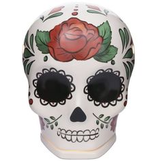 a white sugar skull with a rose on it