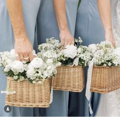 the bridesmaids are holding their bouquets in wicker baskets with white flowers