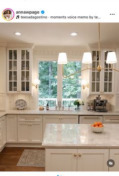 the kitchen is clean and ready to be used for cooking or baking, with white cabinets and marble countertops