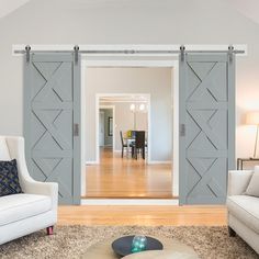 an open living room with sliding doors leading to the dining room