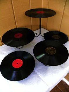 four black records are on a table with white cloth