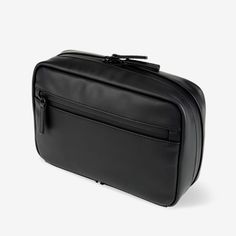 a black leather toiletry bag on a white background