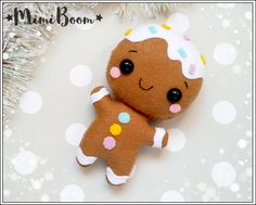 a close up of a small stuffed animal on a white surface with snow flakes