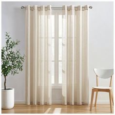 a white chair sitting next to a window with curtains on top of it and a potted plant in front of the window