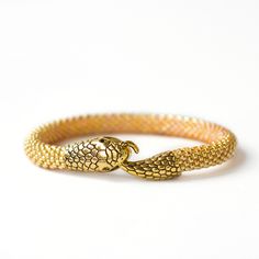 Wonderful gold beaded snake bracelet will be a great gifts for women.This bracelets is made of highest quality Japanese Toho beads.Diameter 0.3 inch. (0.7 cm).IMPORTANT:When choosing the length of the bracelet, keep in mind that the bracelet should be about 1 inch longer than your wrist.It is ABSOLUTELY HANDMADE . So if you like this item in a different color or size, send me a message please. I will send you a link for a "custom order" and you'll be able to place the order there. Please feel fr Ouroboros Bracelet, Serpent Bracelet, Beaded Snake, Ouroboros Snake, Snake Bangle, Tattoo Bracelet, Toho Beads, Snake Jewelry, Snake Bracelet