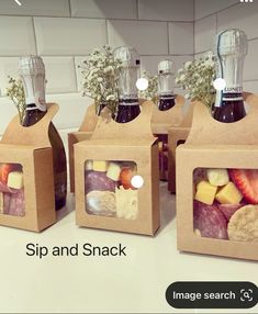 three boxes filled with different types of food on top of a white counter next to each other