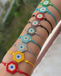 a woman's arm with several bracelets on it