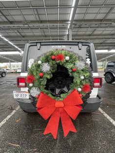 a christmas wreath on the back of a jeep