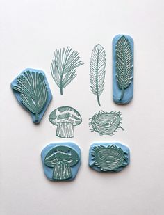 four rubber stamps with different types of leaves and mushrooms in them on a white surface