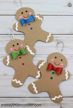 three paper cut out gingers with bows on them