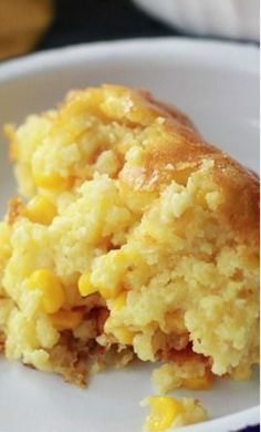 a close up of food on a plate with corn and bread crumbs in it