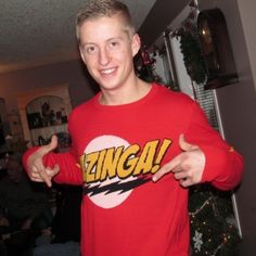 a young man in a red sweater with the word grin on it's chest