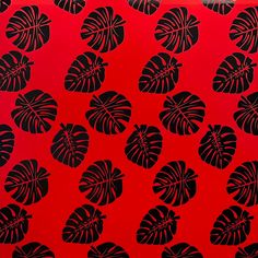 a red background with black leaves on it