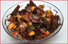 a glass bowl filled with meat and vegetables