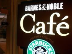 the starbucks sign is lit up for customers