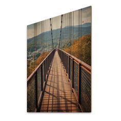 a long suspension bridge with mountains in the background canvas wall art print on wrapped canvas