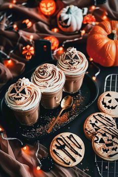 halloween desserts on a table with pumpkins and candles