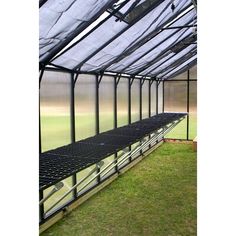 the inside of a greenhouse with green grass