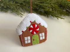 a felt ornament hanging from a christmas tree