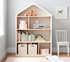 a child's book shelf with books and toys