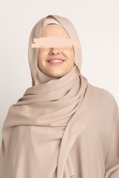 Create effortless hijab styles while feeling relaxed and easy. Our Premium Rayon Hijabs are light and airy to offer easy draping, pleating, and folding that suit your style. The breezy and crisp feel of these hijabs makes them a statement piece for all-year-round wear. Taking it up a notch, our rayon fabric features a subtle sheen that will beautifully accent any ensemble. The lightweight and natural rayon fabric, paired with the subtle crinkle texture, will ensure a fuss-free and on-point look every time. Featured in a warm and creamy beige hue, our Premium Rayon Hijab - Parchment is an incredibly versatile headscarf that you’ll be reaching for repeatedly. Pair with our Tie back Under Caps & Hijab Magnets to keep your hijab and hair in place all day! Modest Beige Hijab For Eid, Solid Color Hijab For Eid, Hijab Magnets, Hijab Colors, Jersey Hijab, Bamboo Shades, Hijab Styles, Hijab Style, Rayon Fabric