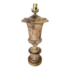 an antique urn is shown against a white background with the light on it's side