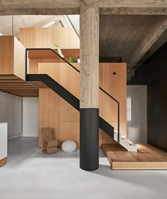 the stairs are made of wood and have black handrails