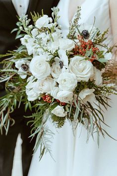 the bride and groom are holding their bouquets