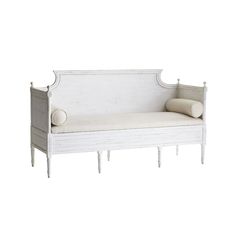 a white couch with two pillows on it's backrests and an arm rest