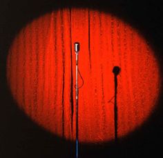 an image of two microphones in the middle of a dark room with red light