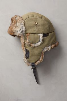 Winter waits at a distance when you're wearing this rugged trapper hat. Our canvas trapper offers the warmth and versatile good looks that take you through winter in comfort. The tightly woven cotton canvas with quilted cotton lining resists wind and cold. And the ultra-soft rabbit fur trim looks great and feels incredible, whether you wear the ear flaps down or tied up with the leather chin strap. Adjustable Winter Adventure Hat, Khaki Hats For Outdoor Fall Use, Khaki Outdoor Hat For Fall, Fall Outdoor Khaki Hat, Military Cotton Hats For Outdoor Activities, Military Style Cotton Hats For Outdoor Activities, Casual Winter Hunting Hats, Winter Hunting Cap, Adjustable Cotton Hats For Winter