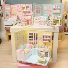 a doll house with furniture and accessories on display in a room filled with other dolls