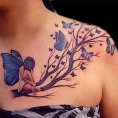 a woman's chest with blue butterflies on it and a tree in the middle