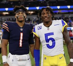 two football players standing next to each other