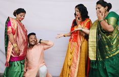 three women and one man are posing for the camera with their hands on their faces