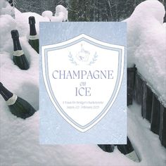 champagne bottles covered in snow next to a sign that says champagne on ice with trees behind it