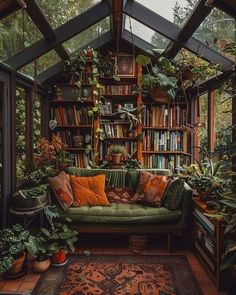 a room filled with lots of green plants and bookshelves on top of it