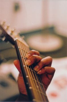 a person holding a guitar in their hand